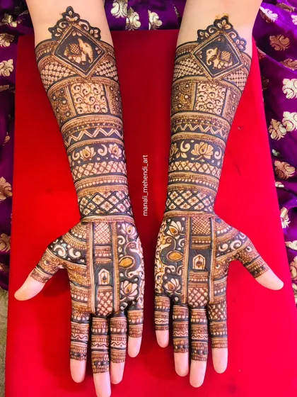The full two-hand view of the previous design, showcasing the symmetrical placement of elephants, lotuses, and peacocks. The dense pattern work is perfect for a traditional bride.