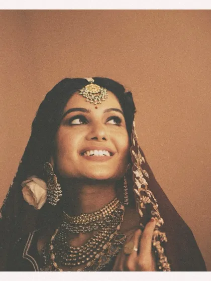 A portrait that feels like a timeless painting. For this campaign, we embraced a vintage aesthetic, using warm, earthy tones and soft lighting to highlight the bride's joyful expression. The layered polki and pearl jewelry and the rich maroon ensemble were curated to evoke a sense of old-world, regal charm.