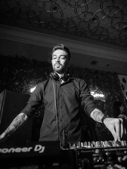 A moody black and white shot of me at the console. The intricate ceiling pattern and lighting add to the atmosphere of this upscale venue, where I was spinning a mix of dark, groovy tracks.
