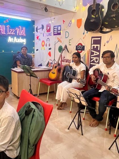 A snapshot of our classroom during a group guitar lesson. With instruments on the walls and students focused on their music sheets, our academy provides an inspiring atmosphere for learning.