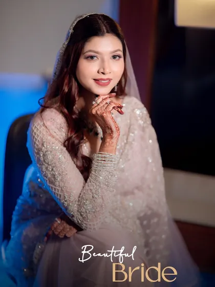 A close-up bridal portrait of Jyoti, highlighting the intricate details of her attire and the delicate henna on her hands. My goal is to capture the bride's radiance and serene beauty.