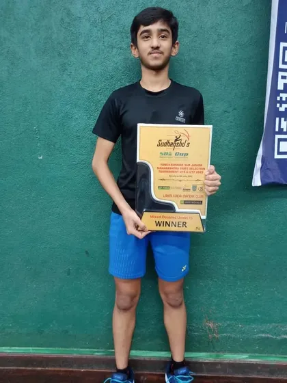 A solo shot of Harshit with his winner's plaque, showcasing his achievement in the mixed doubles category.