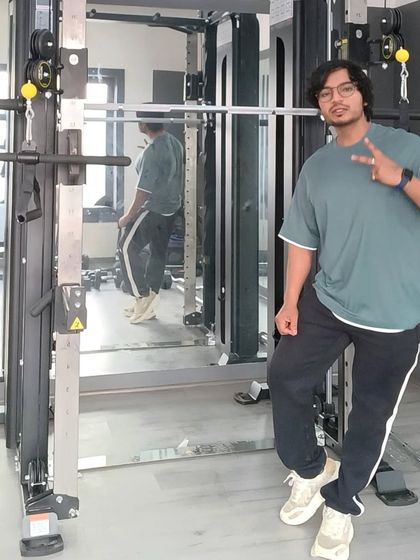 Posing next to the Smith machine. This versatile piece of equipment is great for safely performing squats, presses, and more.