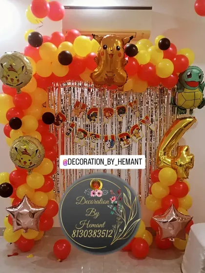 A fun Pikachu-themed birthday decoration for a 4th birthday. The setup includes a balloon arch in the character's signature red, yellow, and black colors, with Pikachu and Squirtle foil balloons.