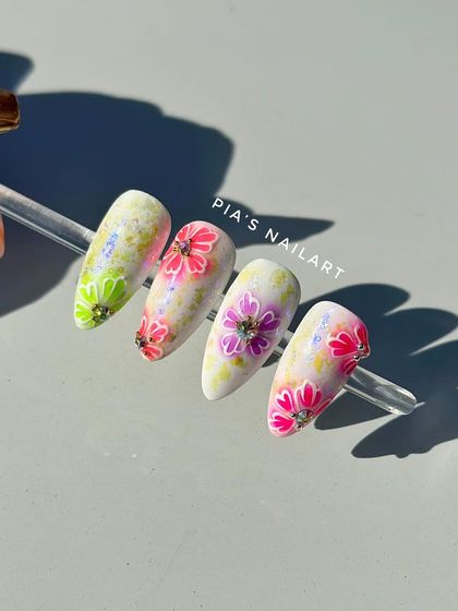 A sample of a new floral design, showcasing vibrant, hand-painted flowers with rhinestone centers on a watercolor-style background.