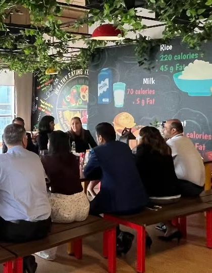 Guests seated at long tables during a corporate lunch. The casual yet professional setting is ideal for team events and client meetings.