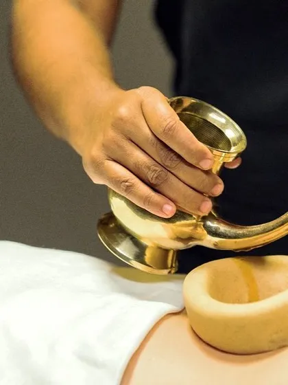 This is Kati Basti, one of our most effective treatments for chronic back pain and sciatica. A dam of herbal dough holds warm, medicated oil over the lower back, deeply nourishing the nerves and relieving stiffness.