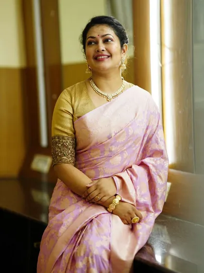 The full look, showing the elegant drape of the pink Banarasi saree paired with a classic gold blouse.