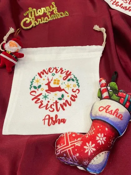 A personalised Christmas stocking ornament and matching 'Merry Christmas' pouch for 'Asha'.