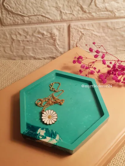 Our original teal and white marble hex tray, styled with a simple daisy necklace. This piece holds a special place in our hearts.