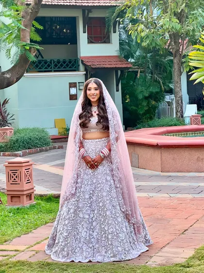 The full view of this stunning bride in her Seema Gujral lehenga. The long, flowing waves add a touch of fairytale romance to her modern bridal look.