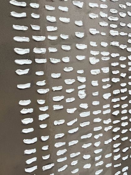 A close-up of another piece for the Agra cafe, this one featuring hundreds of small, white textured dashes on a grey background, creating a pattern reminiscent of script or rain.