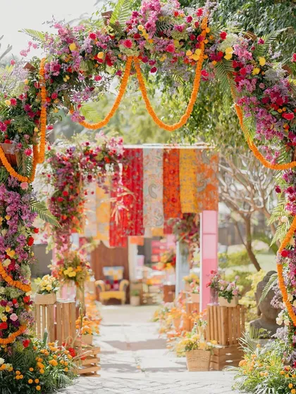 A beautiful floral archway from our 'Rajasthani Folklore' Mehendi. The mix of bougainvillea, marigolds, and other local flowers created a stunning frame for the entrance pathway.