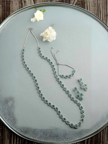 A simple yet stunning single-strand necklace made with green American diamonds, complete with a matching bracelet and earrings. This set is perfect for a minimalist, modern look.