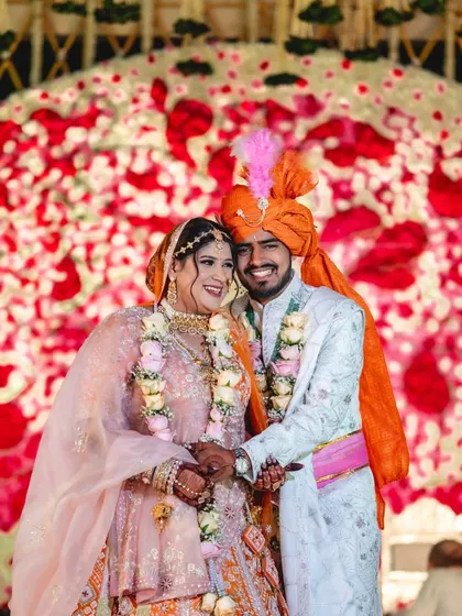 This backdrop of red and white roses is designed to be the perfect frame for wedding portraits. The sheer volume of flowers creates a rich texture and a feeling of pure romance and celebration.