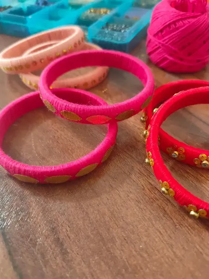A glimpse of my work-in-progress materials. You can see colorful fabric components, beads, threads, and hand-painted pieces all waiting to be turned into beautiful jewelry.