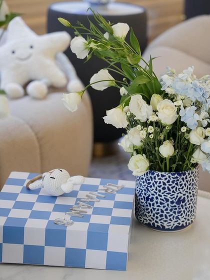 A detail shot of a checkered gift box and a small floral arrangement.