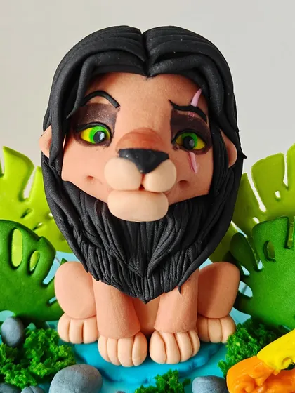 A close-up of the handcrafted fondant Scar topper from the Lion King cake, showing the detailed work that goes into each character to capture their personality.