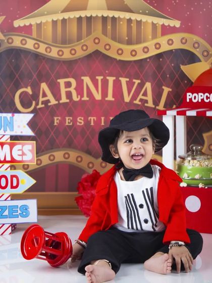 Welcome to the carnival! This little showman is ready to entertain, dressed in a red jacket and bow tie.
