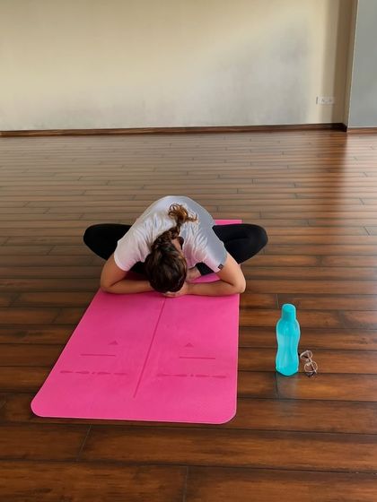 A student finds release in Baddha Konasana (Bound Angle Pose), a moment of quiet surrender.