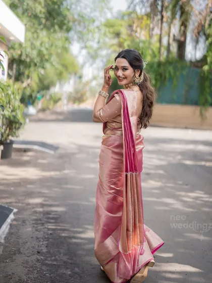 A beautiful back shot showing Isha's complete look, including her hairstyle and the drape of her saree. Every detail matters for the perfect bridal look.