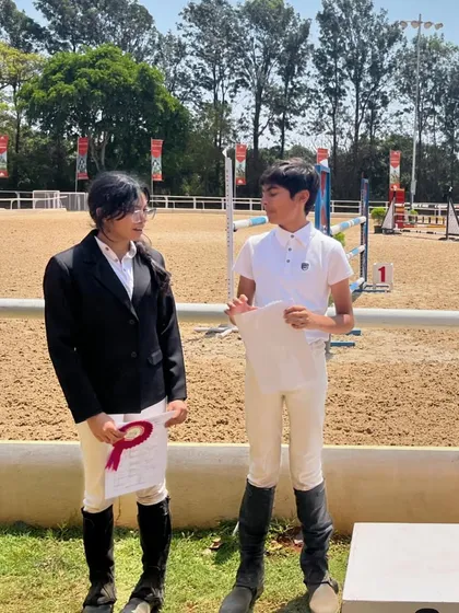 Two of our riders discussing their performance after the competition. Peer support and learning are a big part of our team culture.
