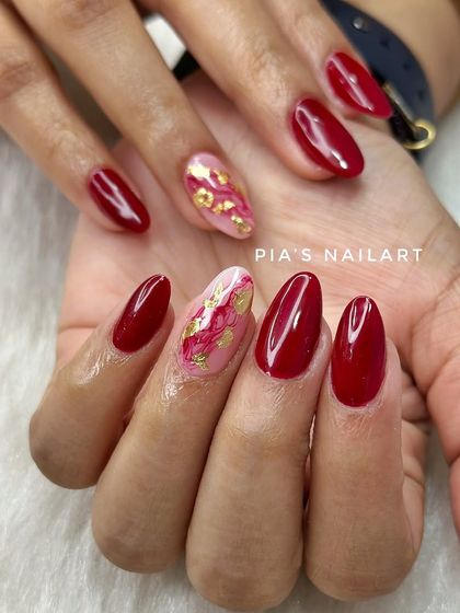 Classic red acrylic extensions with a beautiful marble and gold foil accent nail.