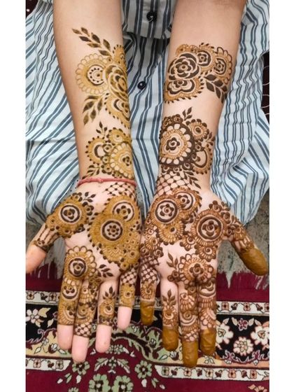 This design features a mix of circular mandala patterns and floral elements, creating a rich and detailed look. The stain is just beginning to set, showing the fresh application.