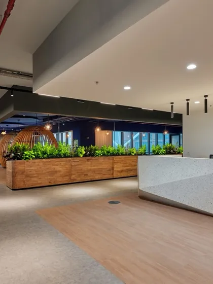 A large wooden planter box acts as a space divider and a central green feature in this reception area.