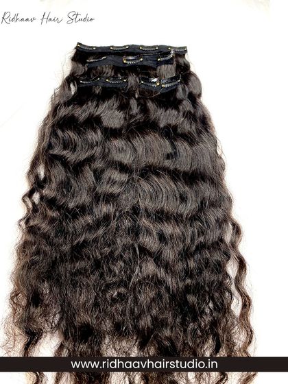 Full view of our 4-piece curly clip-in extensions, showcasing the rich texture and volume you can achieve in minutes.
