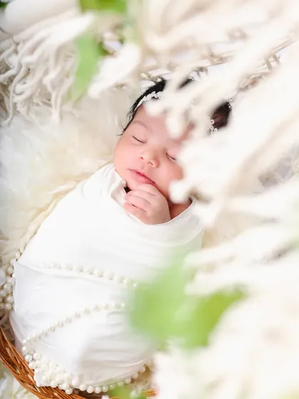 Another artistic angle, using the foreground to create depth and draw the eye to the peacefully sleeping baby.