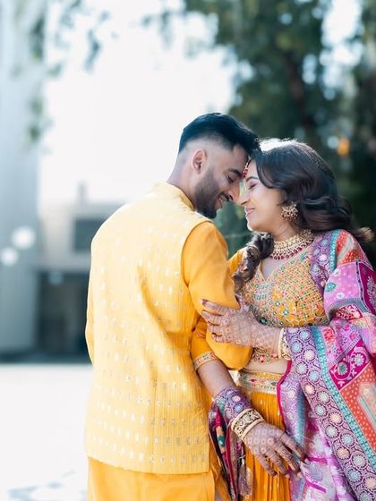 A romantic moment between a couple, touching foreheads during their outdoor shoot.