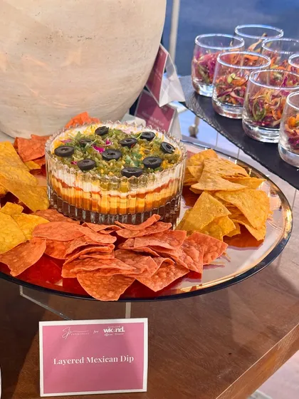 Our 7-layer Mexican dip, a crowd-pleasing centerpiece, served with colourful tortilla chips.