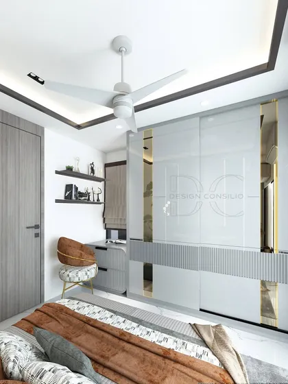 This master bedroom design features a sleek sliding wardrobe with high-gloss white and gold-tinted mirror panels. The dark wood flooring and grey tones create a modern and masculine vibe.