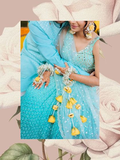A beautiful detail shot of the couple's hands adorned with floral jewelry during their Haldi ceremony.