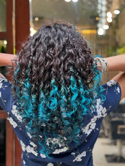 Ready for a pop of color? This vibrant turquoise look shows how we can add bold, fun colors to your curls while maintaining their health and definition using post-color bond repair treatments.