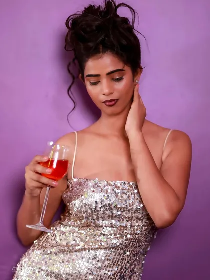 A pensive and graceful pose. The soft lighting and her expression create a quiet, intimate moment.