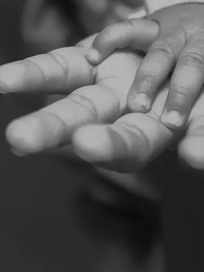 A tiny hand holding on, a simple yet powerful symbol of trust and connection. I believe these small, black and white detail shots often tell the biggest stories about family bonds.