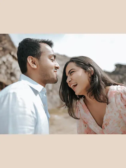 Sharing a laugh, nose-to-nose. This candid and joyful image captures the pure happiness of being together in a beautiful, natural setting.