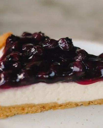 A perfect slice of our Blueberry Cheesecake. The buttery cookie base provides a wonderful textural contrast to the smooth cream cheese filling and the sweet, tangy blueberry compote we make in-house.