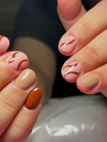 For the love of browns and curves. This set features a mix of solid brown shades and abstract swirl designs on a nude base.