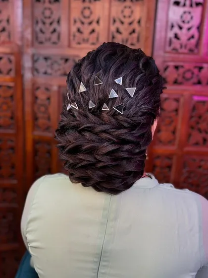 Another angle of the modern textured bun with mirror accessories, showing the intricate weaving and detail.