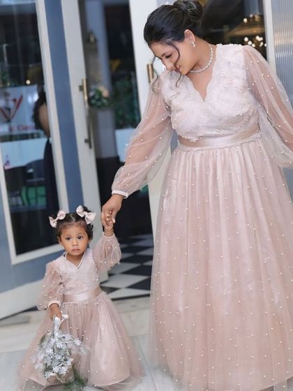 Delicate and dreamy, this matching set in soft pink features sheer, pearl-studded balloon sleeves. It's a beautiful option for a birthday party or a special event.