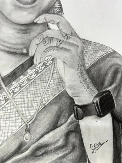 A close-up view of the hand from the previous portrait, showing the detailed line work of the henna design and the texture of the sari fabric.