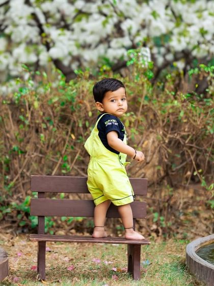 Capturing a toddler on the move in a beautiful park setting. The natural environment provides a perfect playground for authentic and lively children's portraits.
