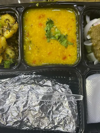 A simple and light thali with jeera aloo and yellow dal. This is a great option for those who prefer a less spicy and oily meal.
