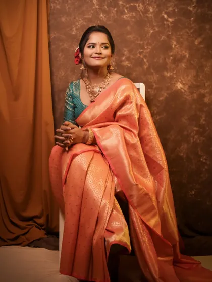 The full look, with the peach saree beautifully draped to create an elegant and timeless portrait.