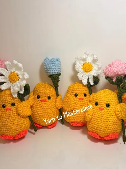 Another group shot of the chicks with flowers, showing the variety of colors and flower types available for customization.