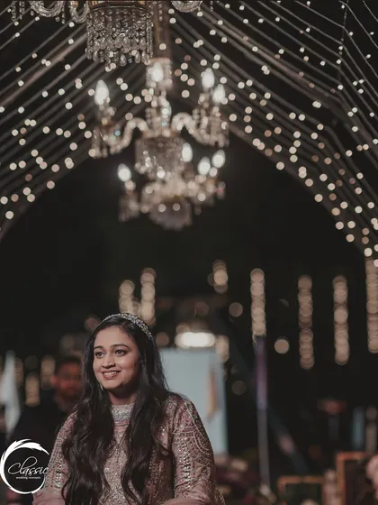 A candid moment of the bride enjoying the Sangeet atmosphere I created. The ceiling is a galaxy of fairy lights and crystal chandeliers, making the whole space sparkle.