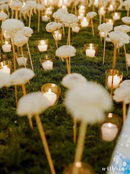 A close-up of the candle and paper flower installation on the dance floor. This handcrafted detail shows our commitment to creating unique and beautiful moments within a larger event.